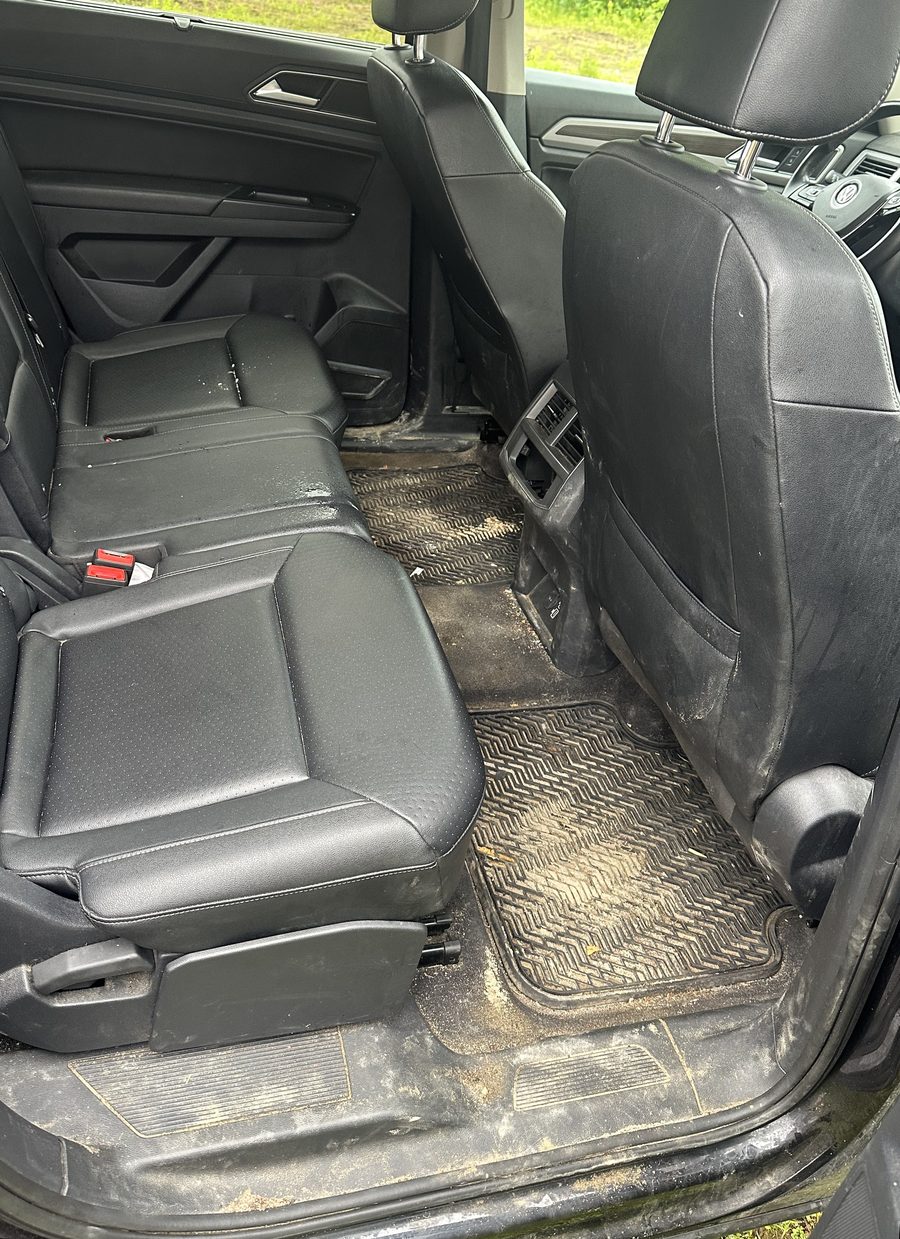 Dusty rear seats and floor mats before interior detailing