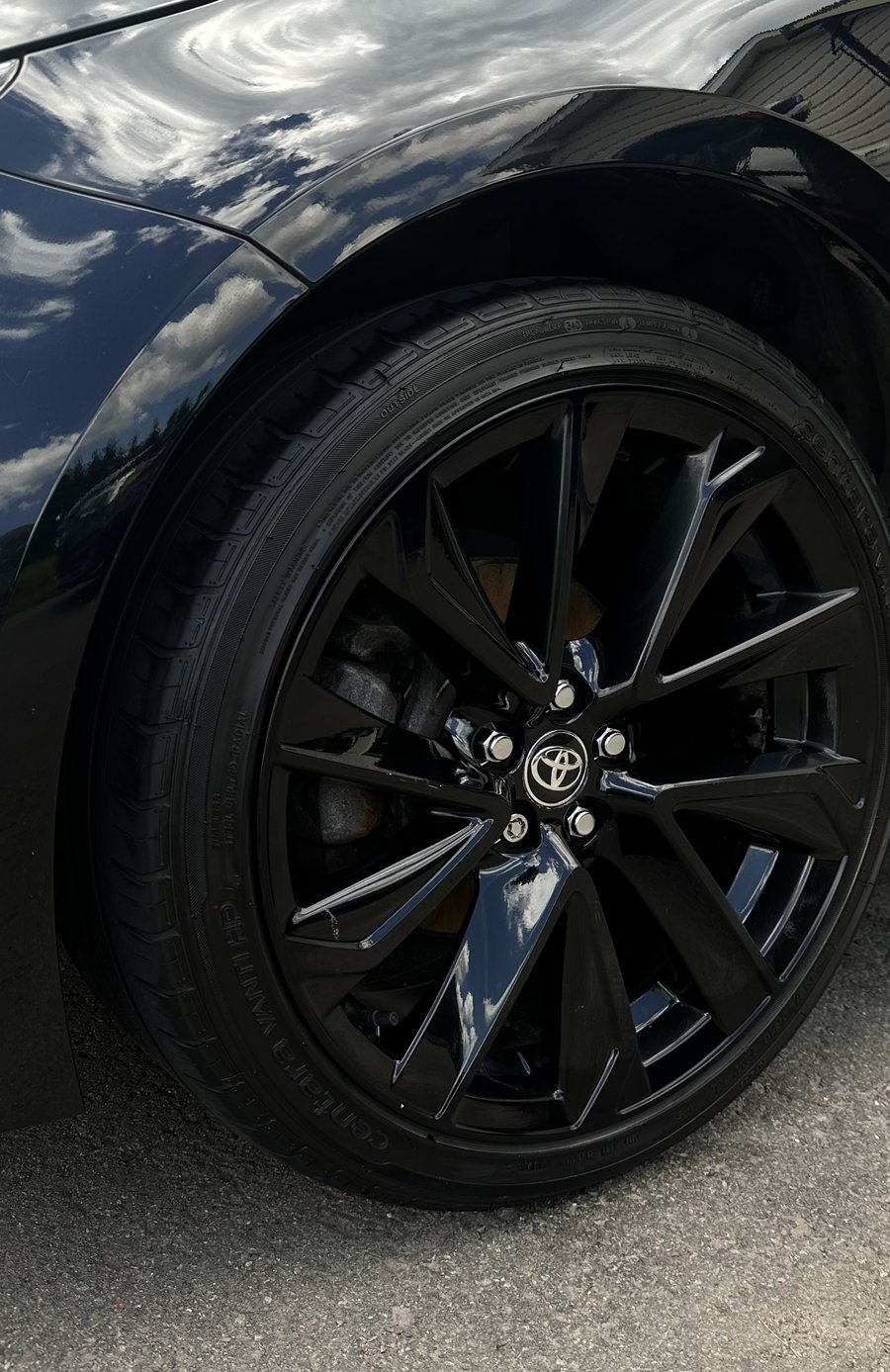 Glossy, clean black wheel and tire after a wheel detail