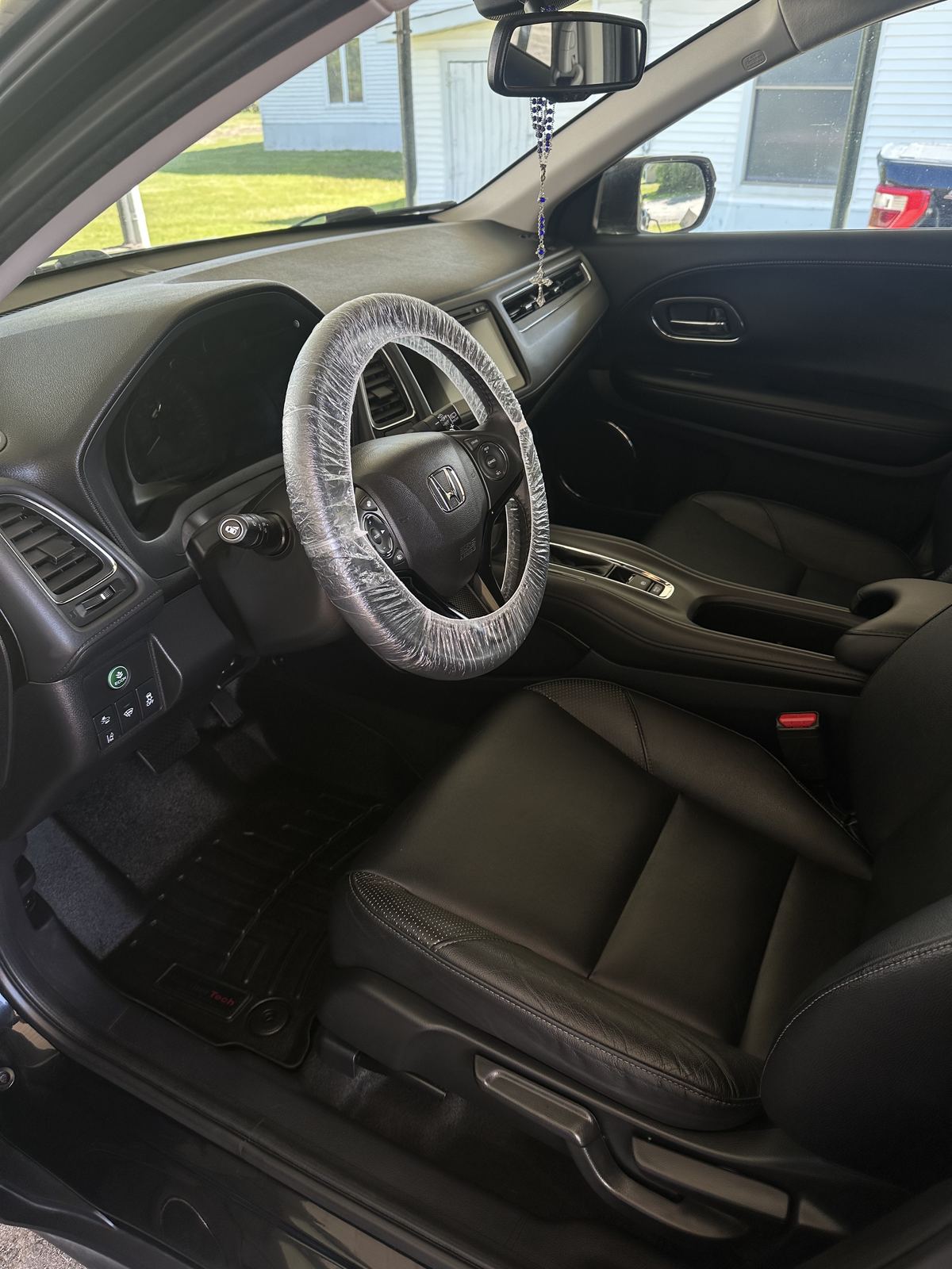 Freshly detailed interior with protective wrap on the steering wheel